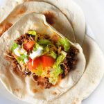 Burritos with beef, cheese, avocado and salad